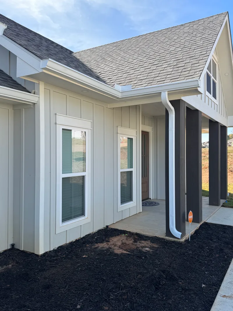 Downspout installation detail on a Texas property